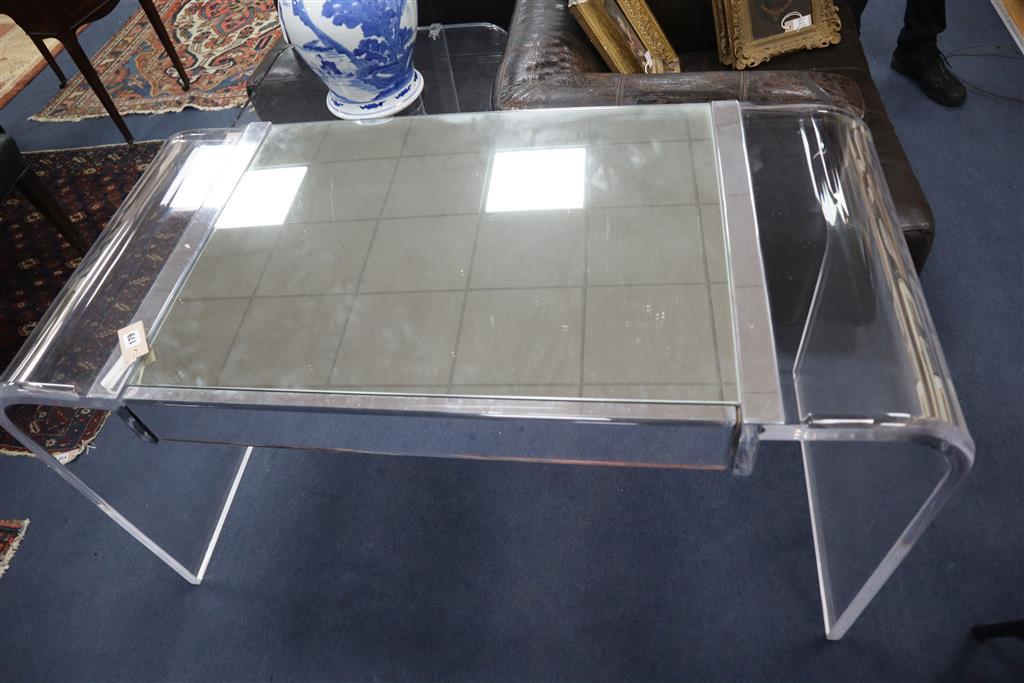 A 1970s Lucite desk with part mirrored top, width 130cm, depth 60cm, height 73cm